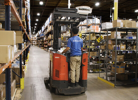 Warehouse worker on standing lift